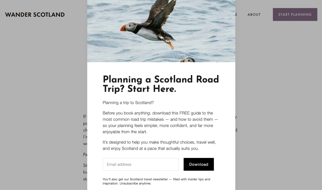 A pop-up form with the heading “Planning a Scotland Road Trip? Start Here” with an email field and a photo of a puffin flying over the water