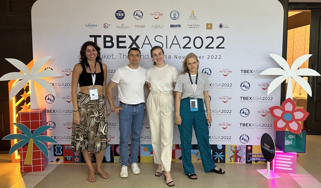 Travelpayouts team near the TBEX Asia 2022 banner