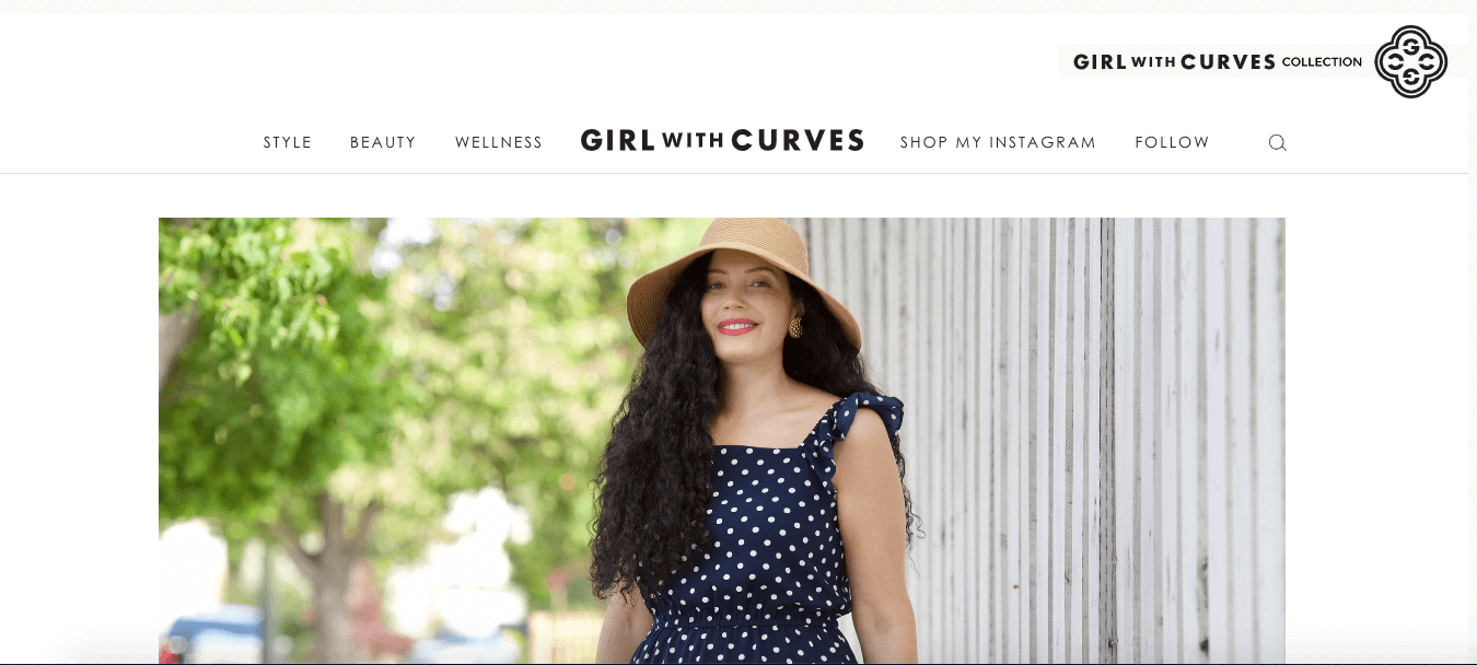 Screenshot of “Girl with Curves,” a fashion website for curvy women featuring a woman with a camel hat and polka dot dress.