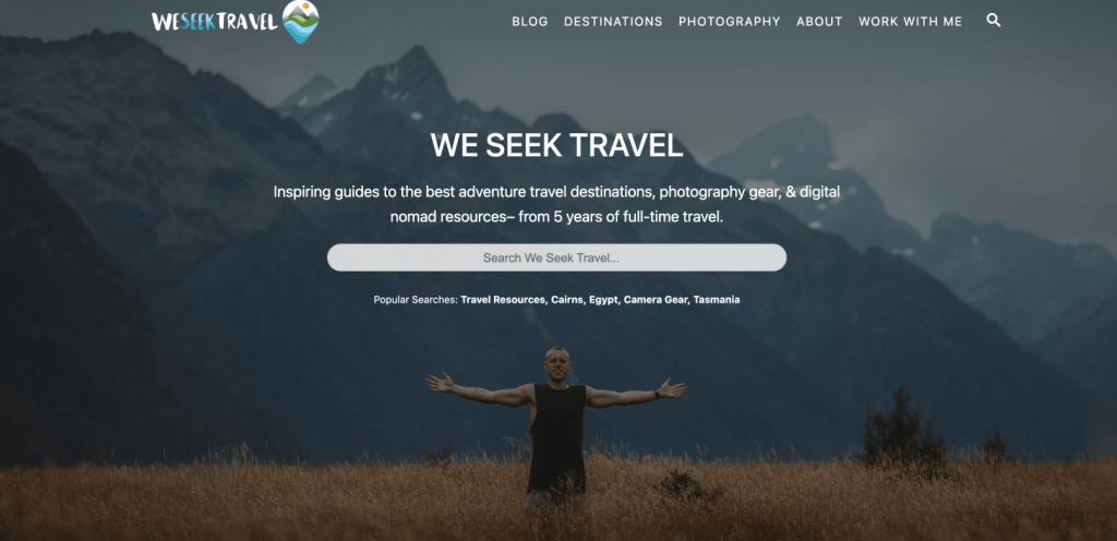 We Seek Travel blog homepage with a photo of the blogger in front of a mountain range with a search bar to find articles