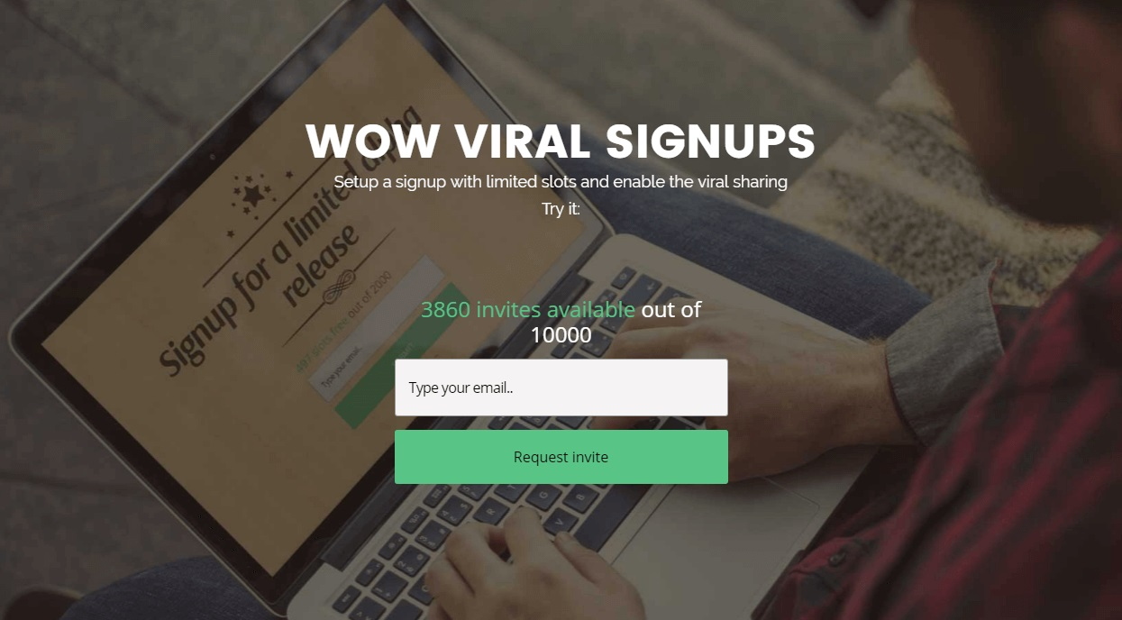 A screenshot of the Wow Viral homepage featuring a signup form and a photo of a person typing on a laptop