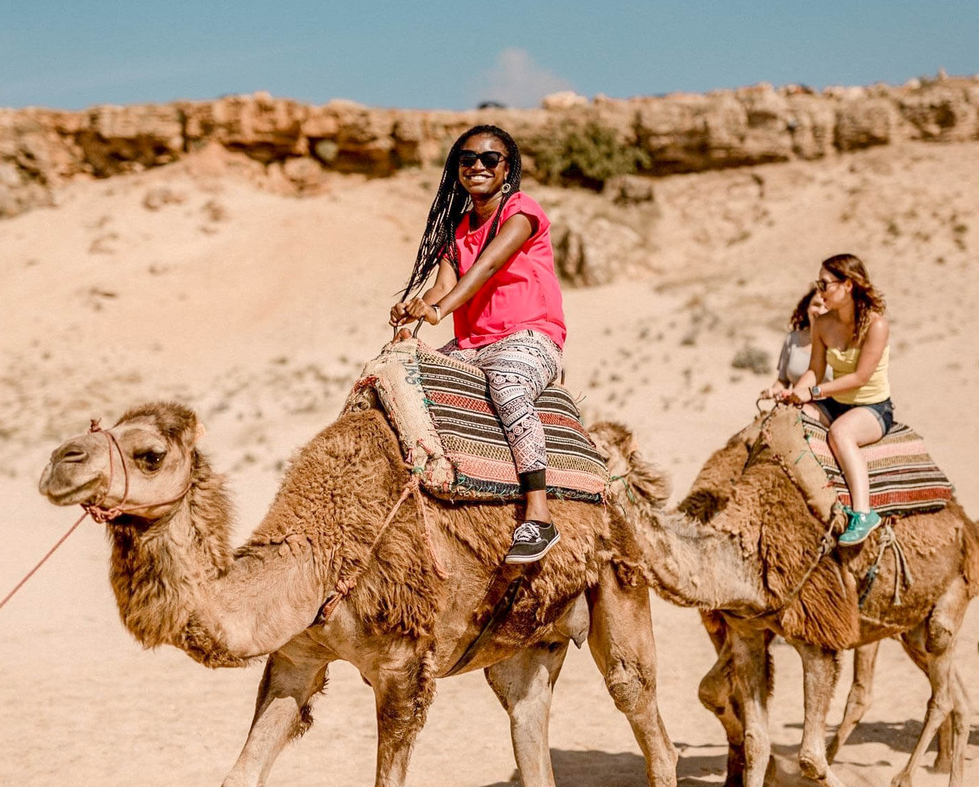 Photo of Somto, author of the blog Somto Seeks camel riding in Morocco