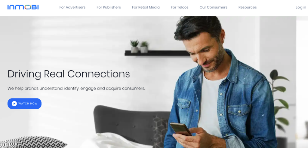 A screenshot of the Inmobi homepage featuring a photo of a man with a phone